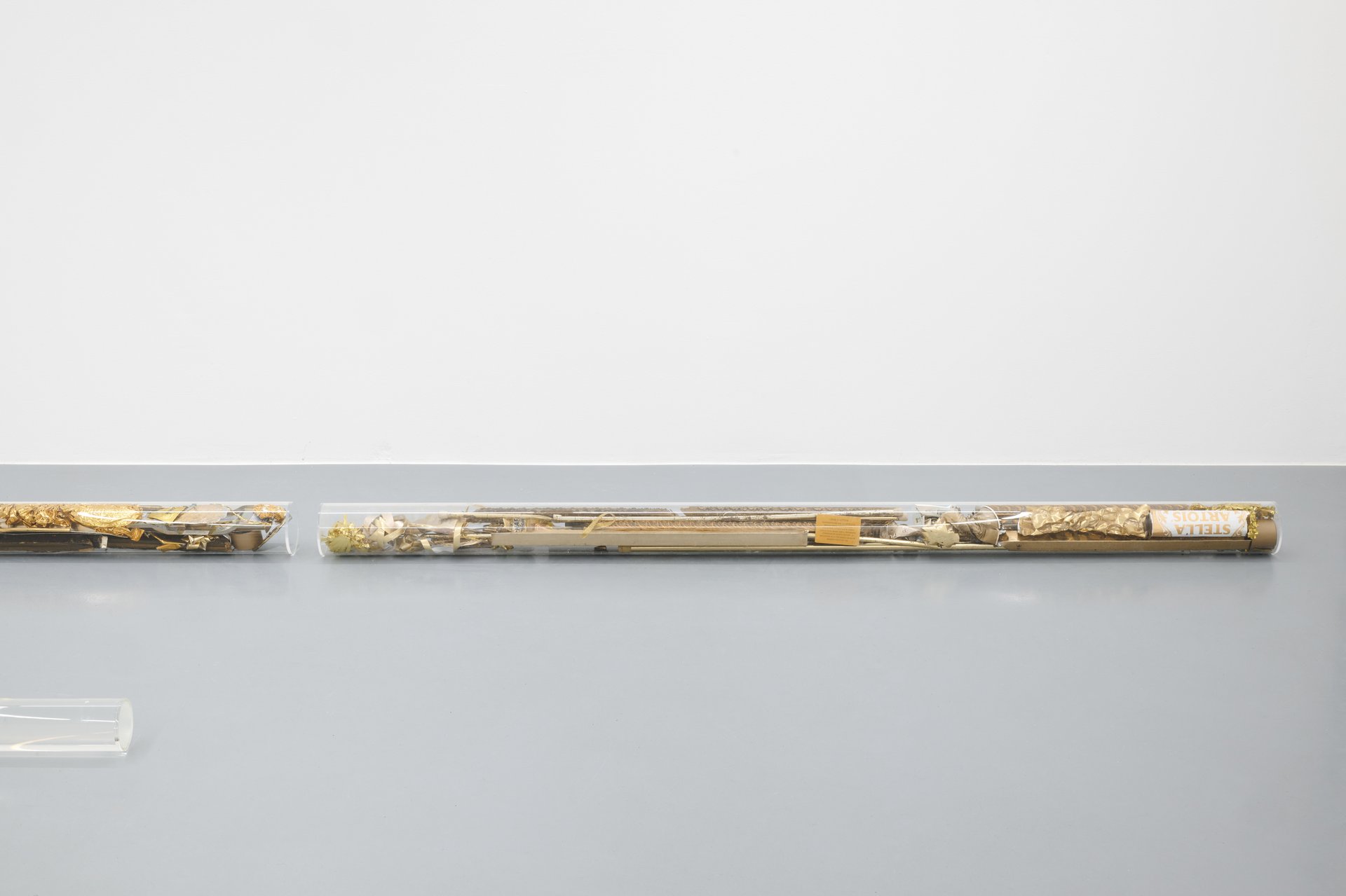 Gianna Surangkanjanajai, Untitled, 2022, two plexiglass cylinders, found objects, each 10 x 184 x 10 cm; Untitled, 2023, six plexiglass cylinders, craft glue, each 8 x 200 x 8 cm.