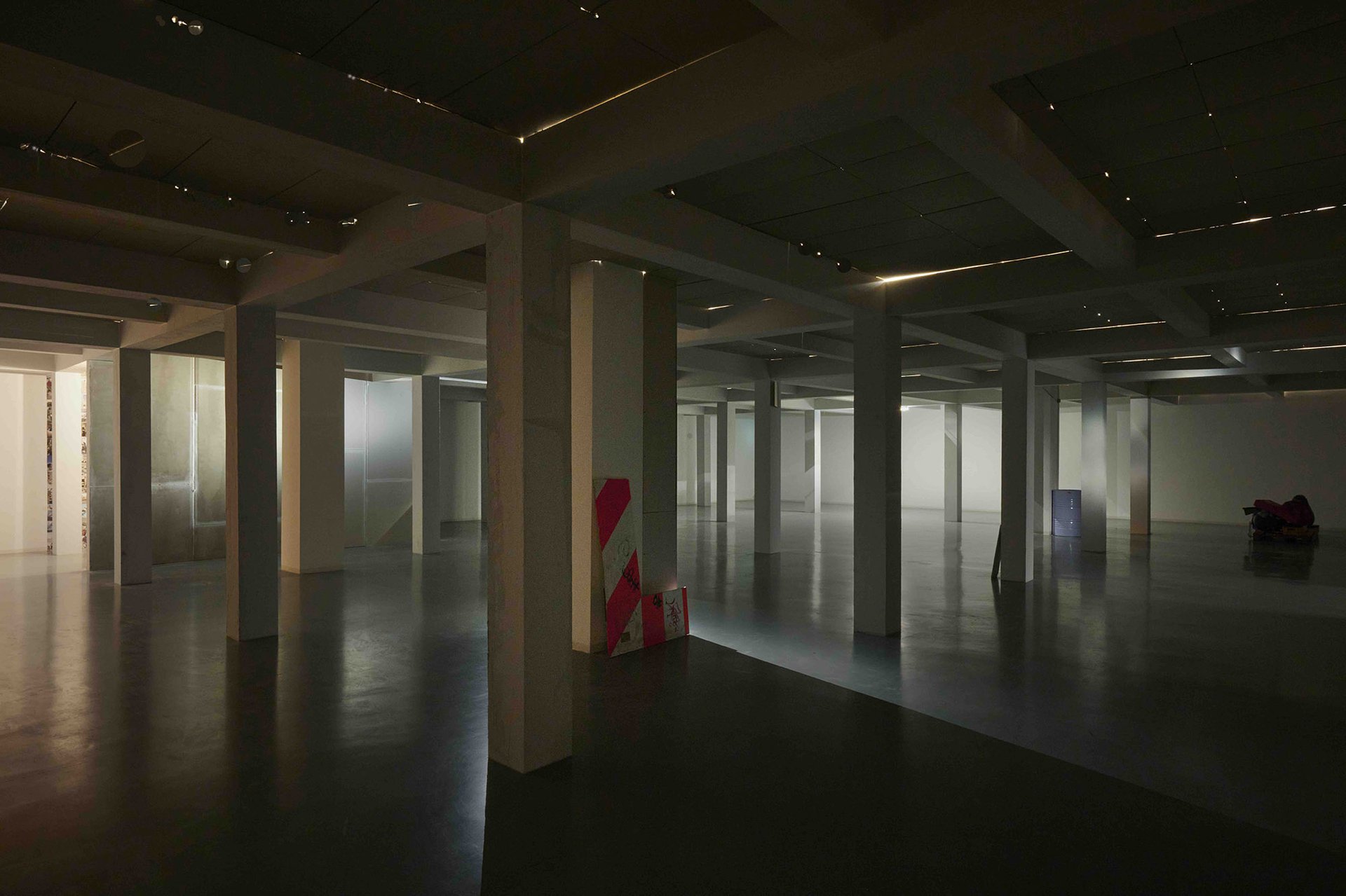Tolia Astakhishvili, Entire, 2023, plaster boards, filler, ventilation shaft grille, pipe, building sight sign, gym mats, punch bag, artificial snow, lamps, sound, 6 m high ceiling suspended to 3 m x 15 m x 22,8 m.